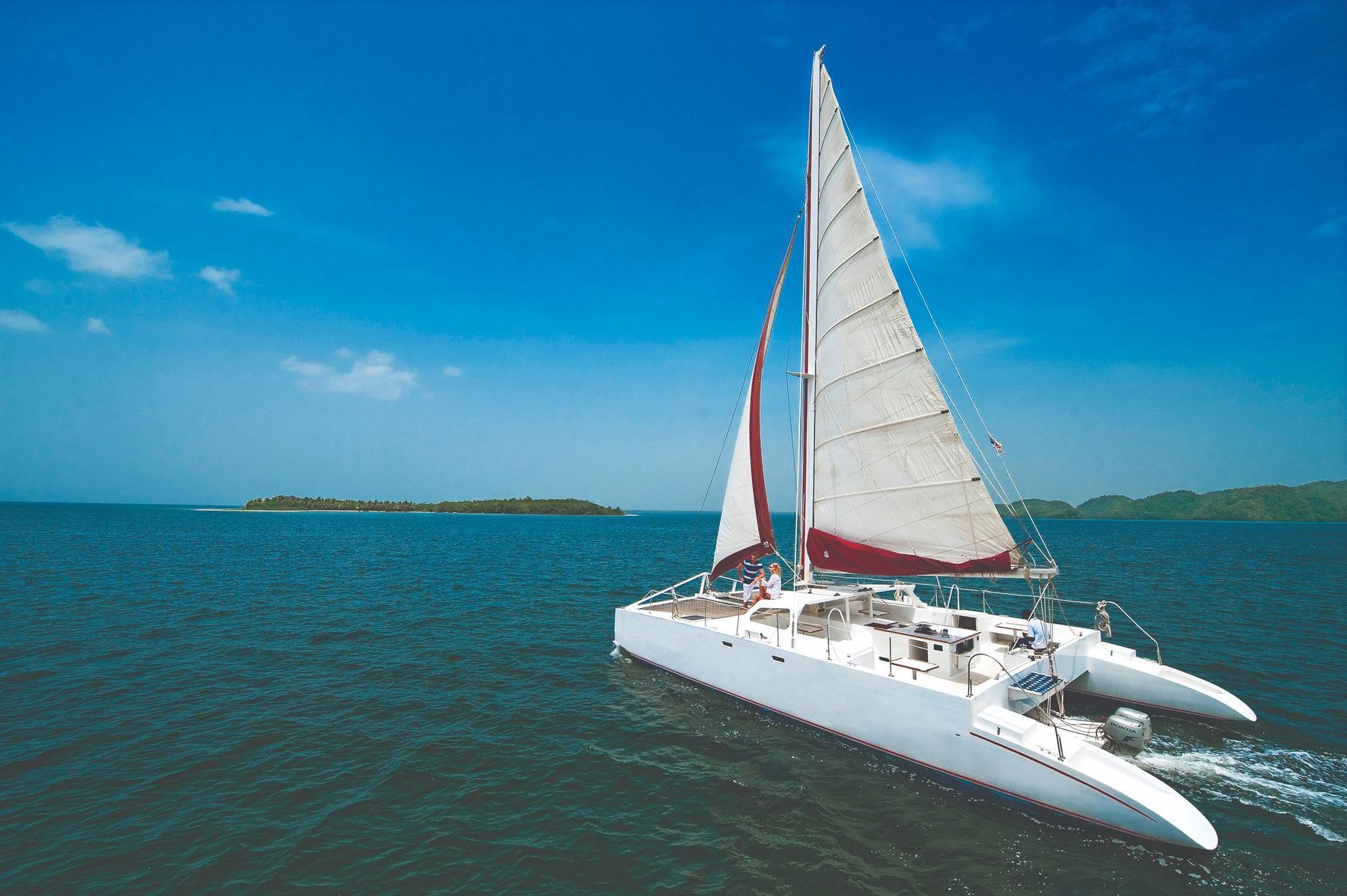 A white catamaran sailing on blue water in the Dominican Republic