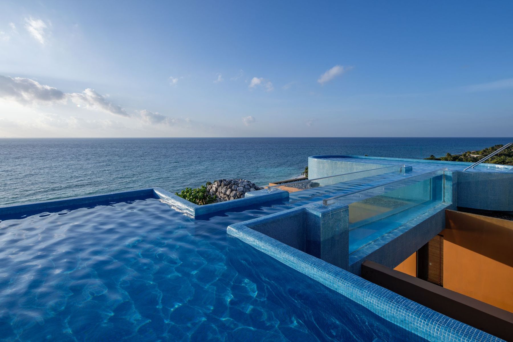 A rooftop infinity pool facing the Caribbean at Hotel Xcaret Arte