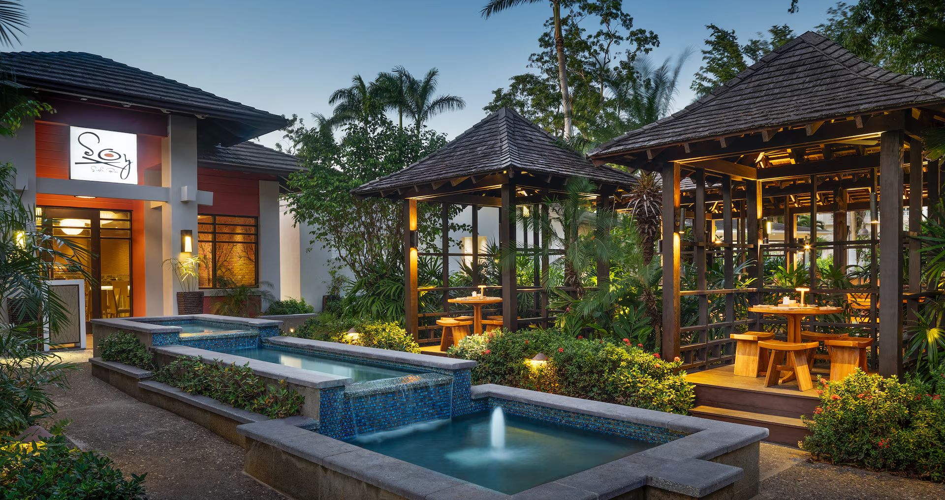 Soy, the Asian restaurant at Beaches Negril, lit up in the garden