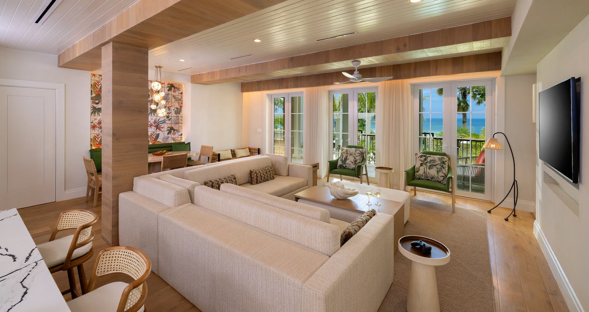 A suite living room with an L-shaped sofa and sea views