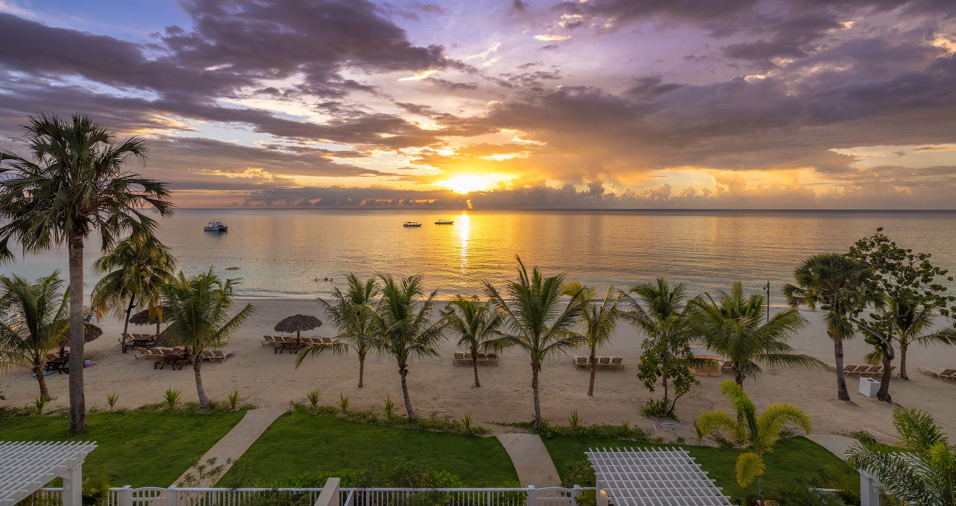 Sunset over the sea and palms at Beaches Negril