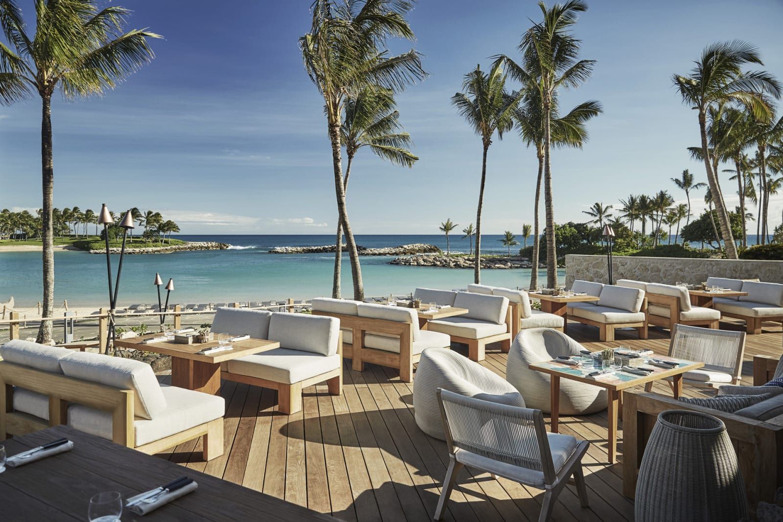 Mina's Fish House terrace, set between the palms and the sea