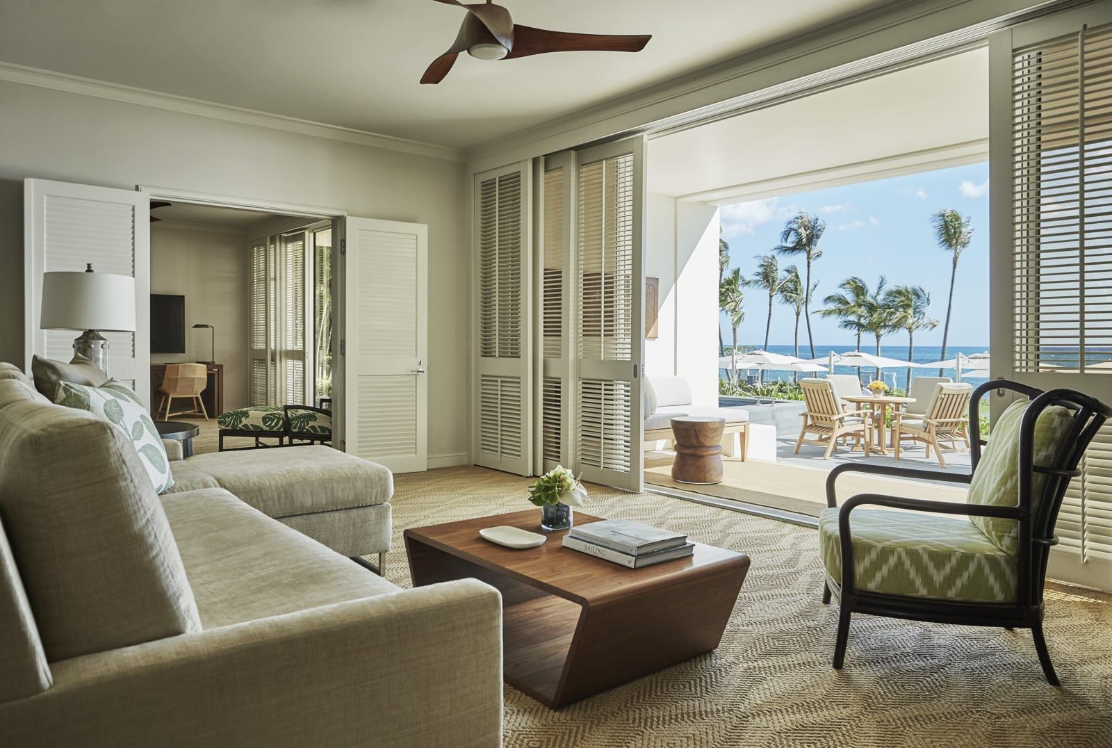 A suite sitting room with doors open to the ocean