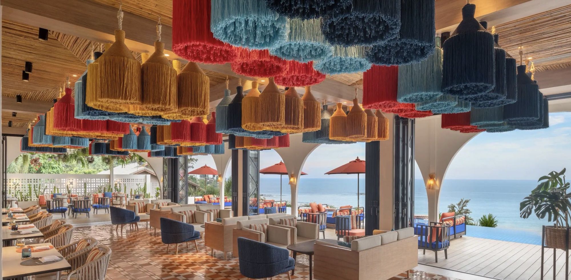 An open-air restaurant under woven lantern shades