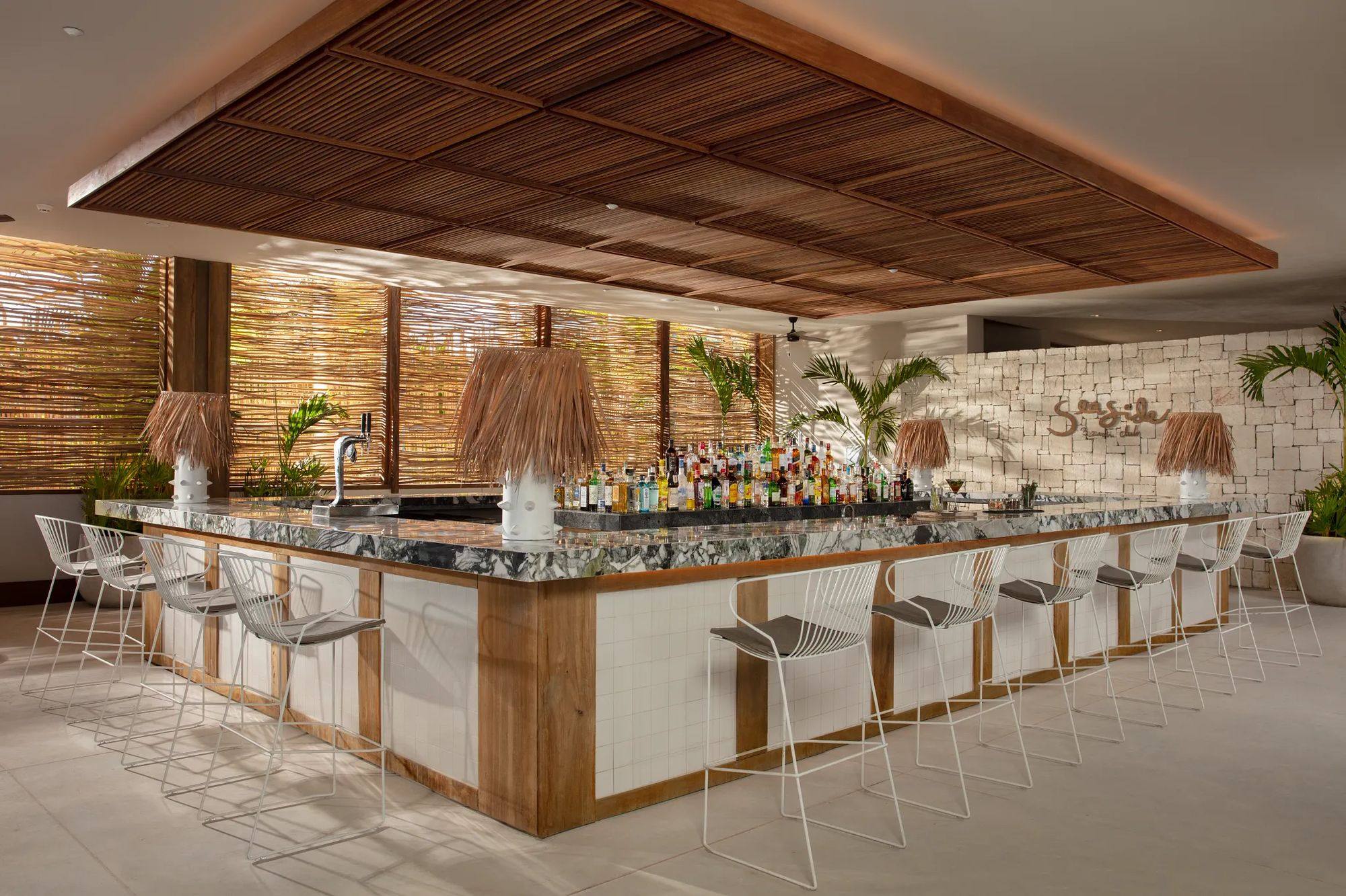 The Seaside Beach Club bar under a slatted wooden roof