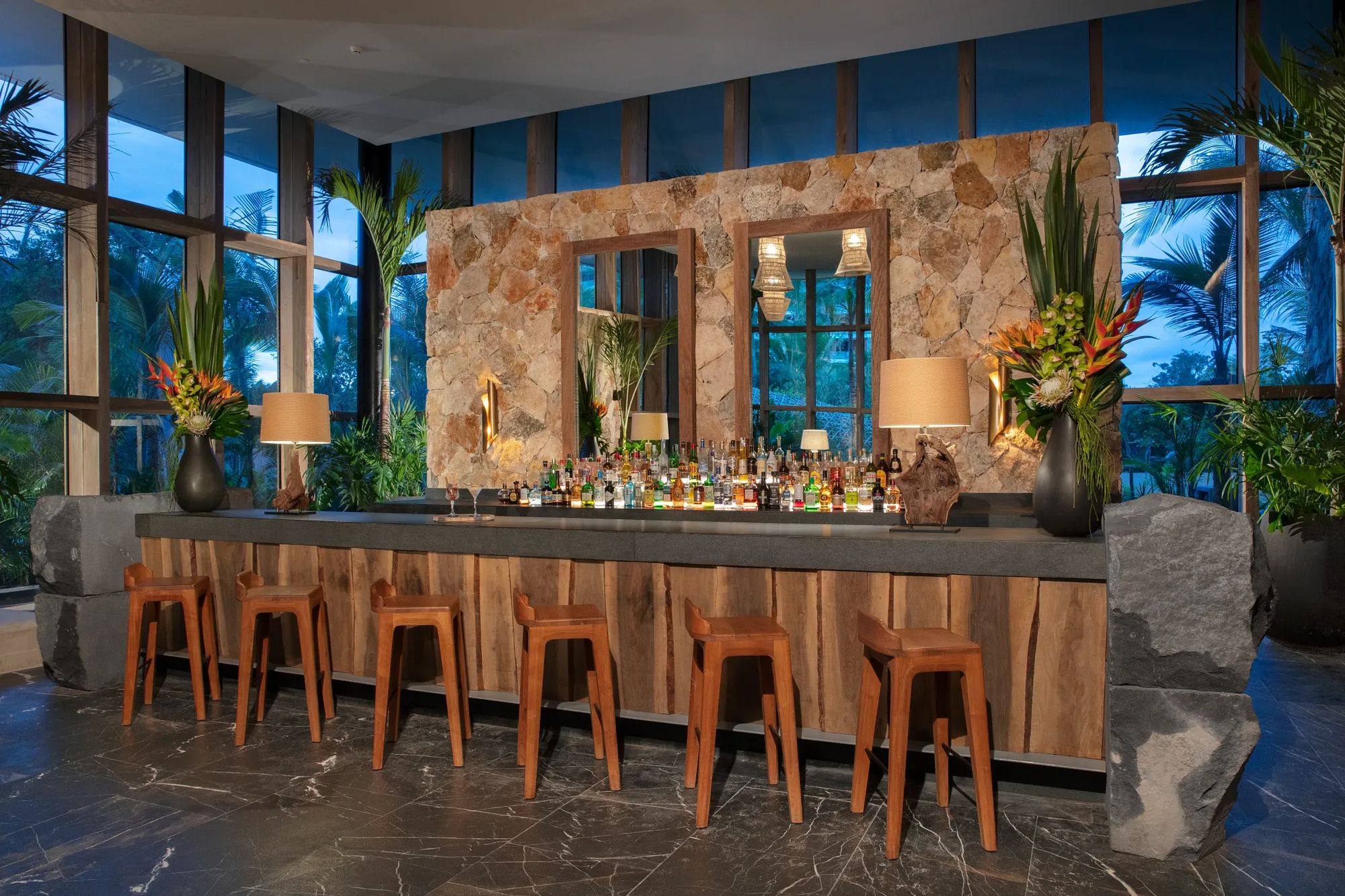 The lobby bar, with a stone wall and copper stools