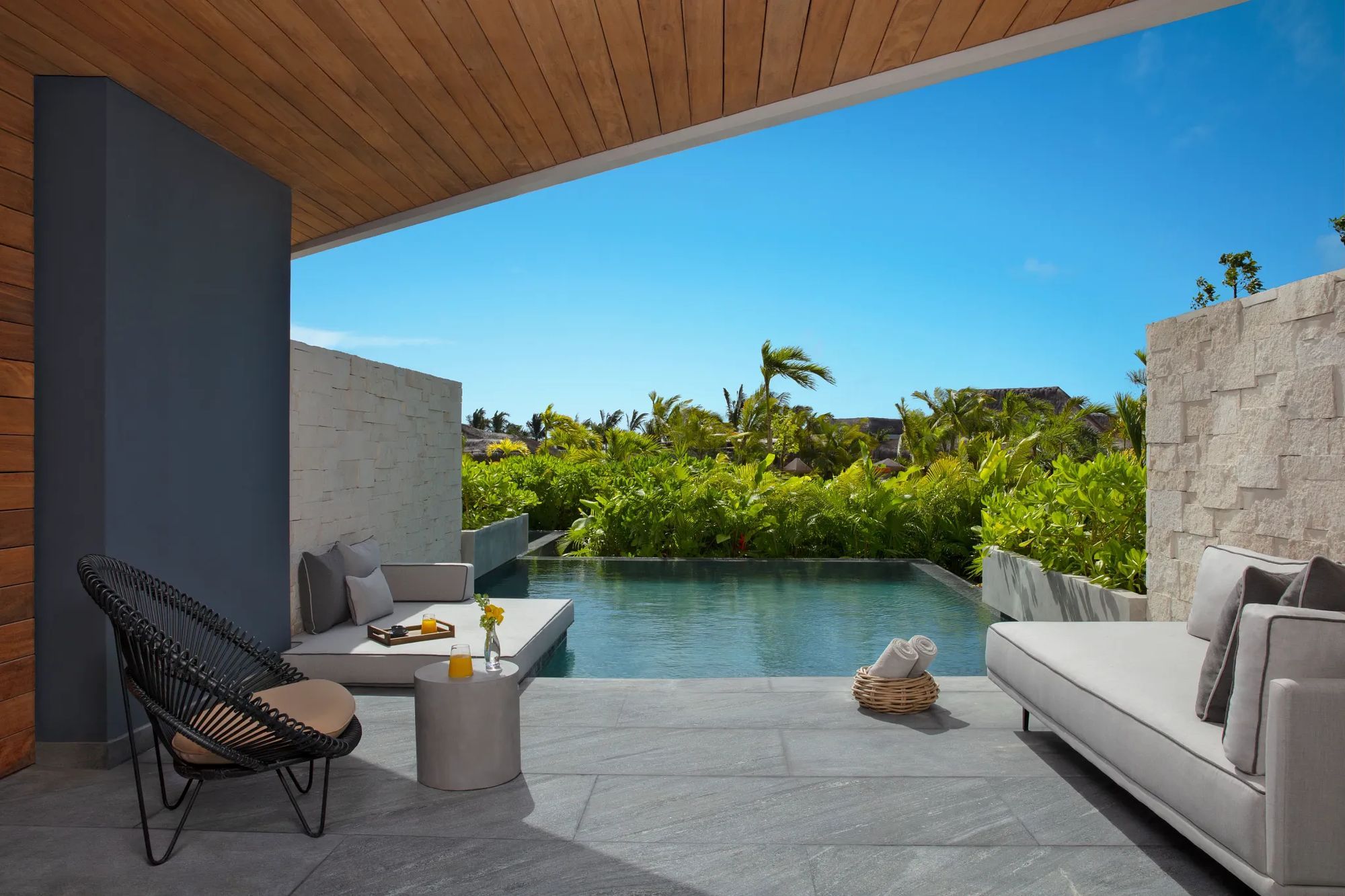 A swim-out suite terrace with a private pool and garden