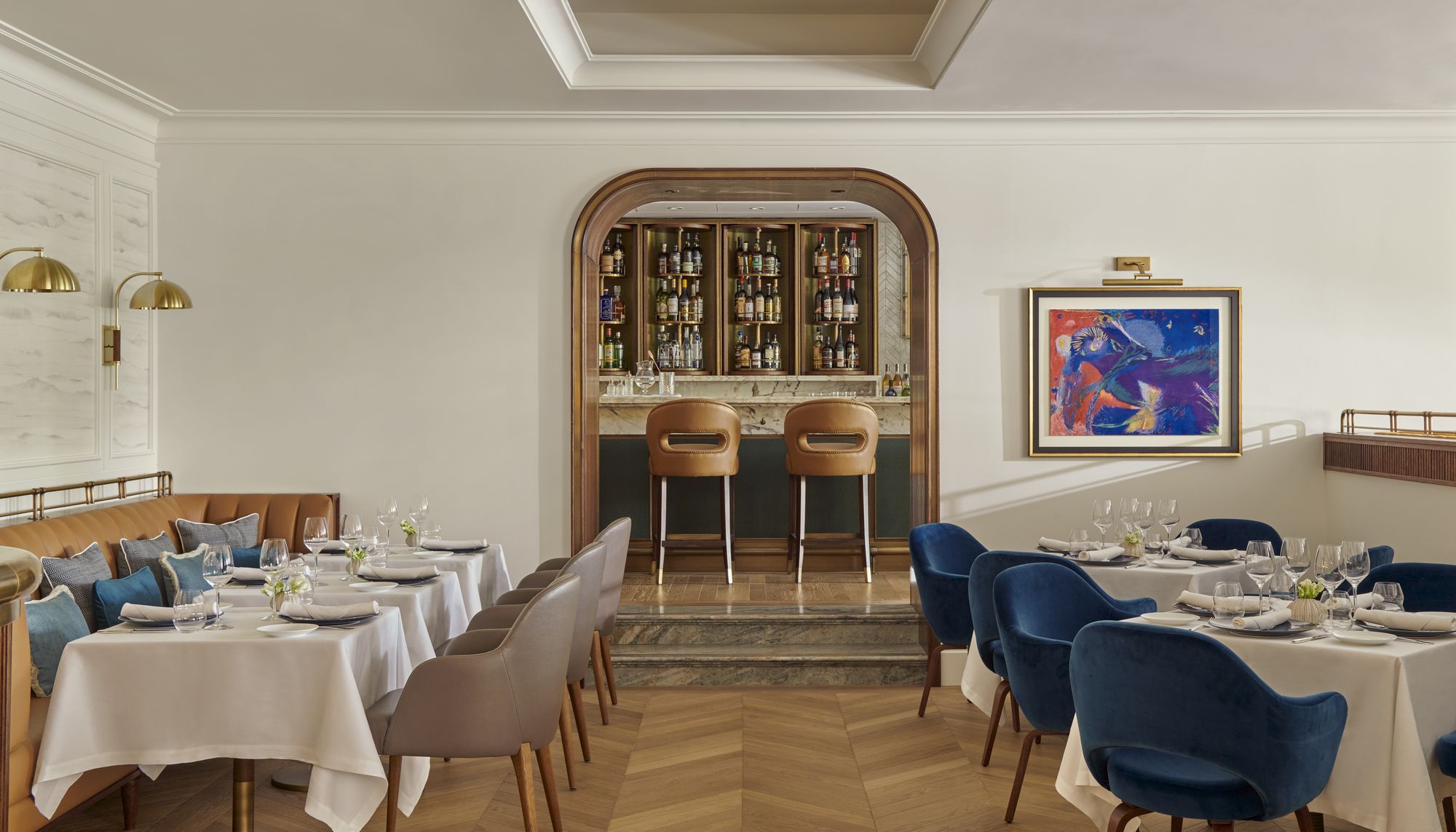 Al Mare's dining room, with blue chairs and an arched bar