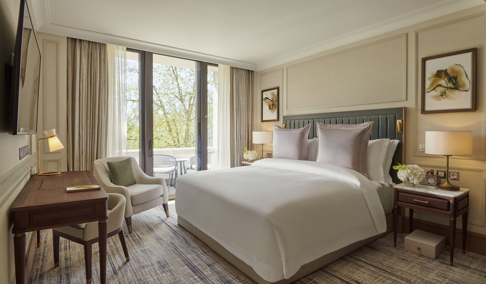 A Garden Suite bedroom with tall windows onto Cadogan Gardens