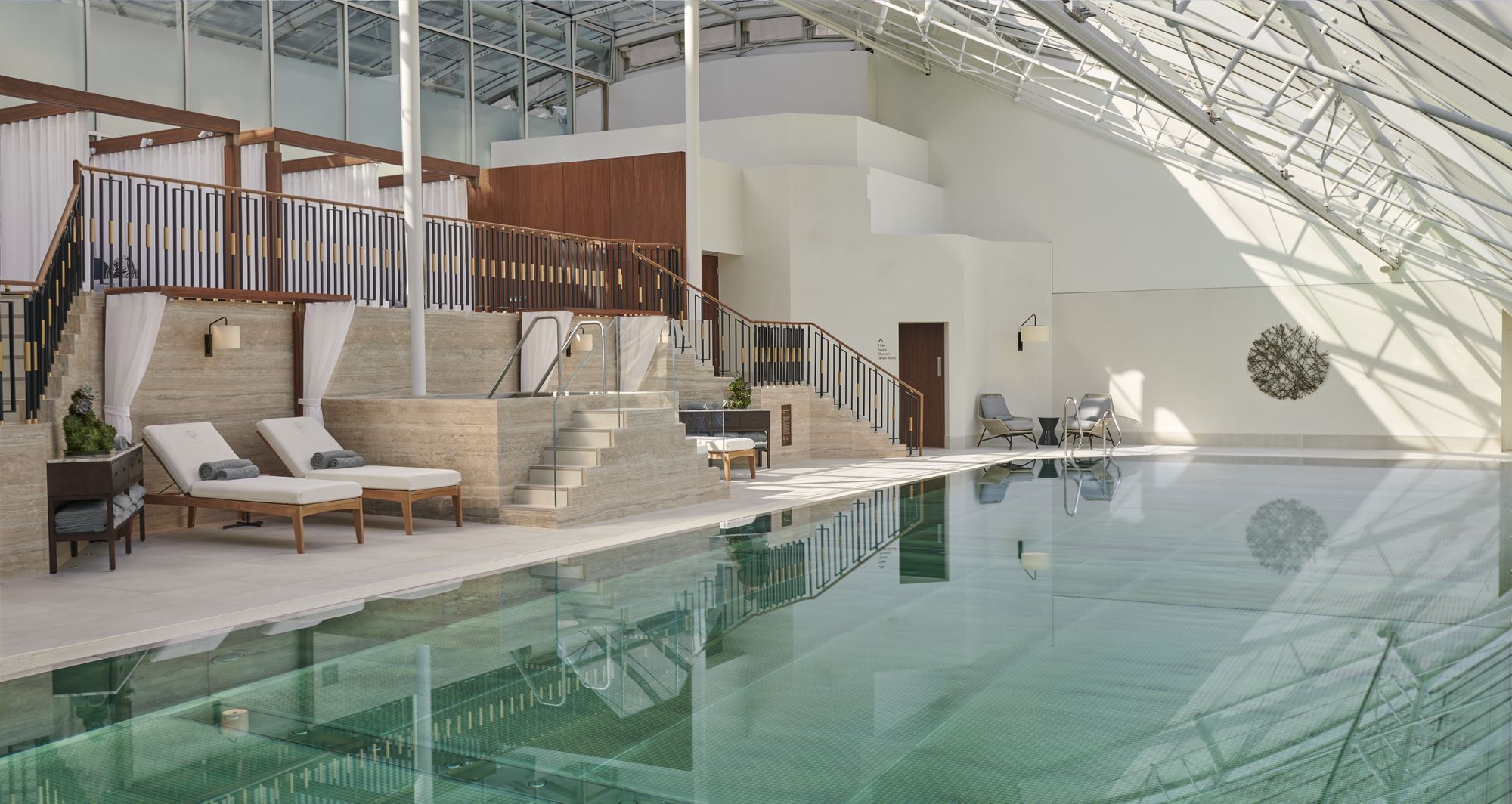 The indoor pool beneath a glass roof at The Peak