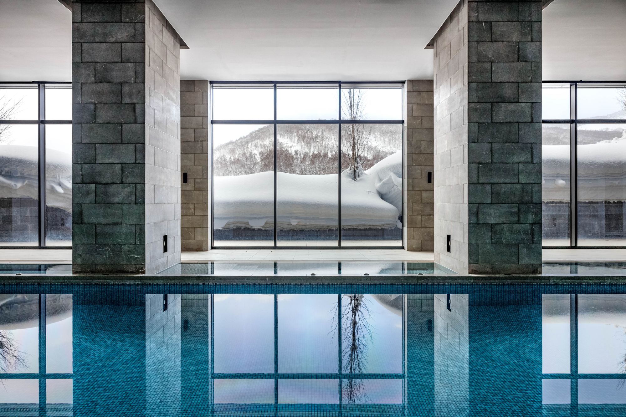 The indoor pool, with tall windows onto the snow