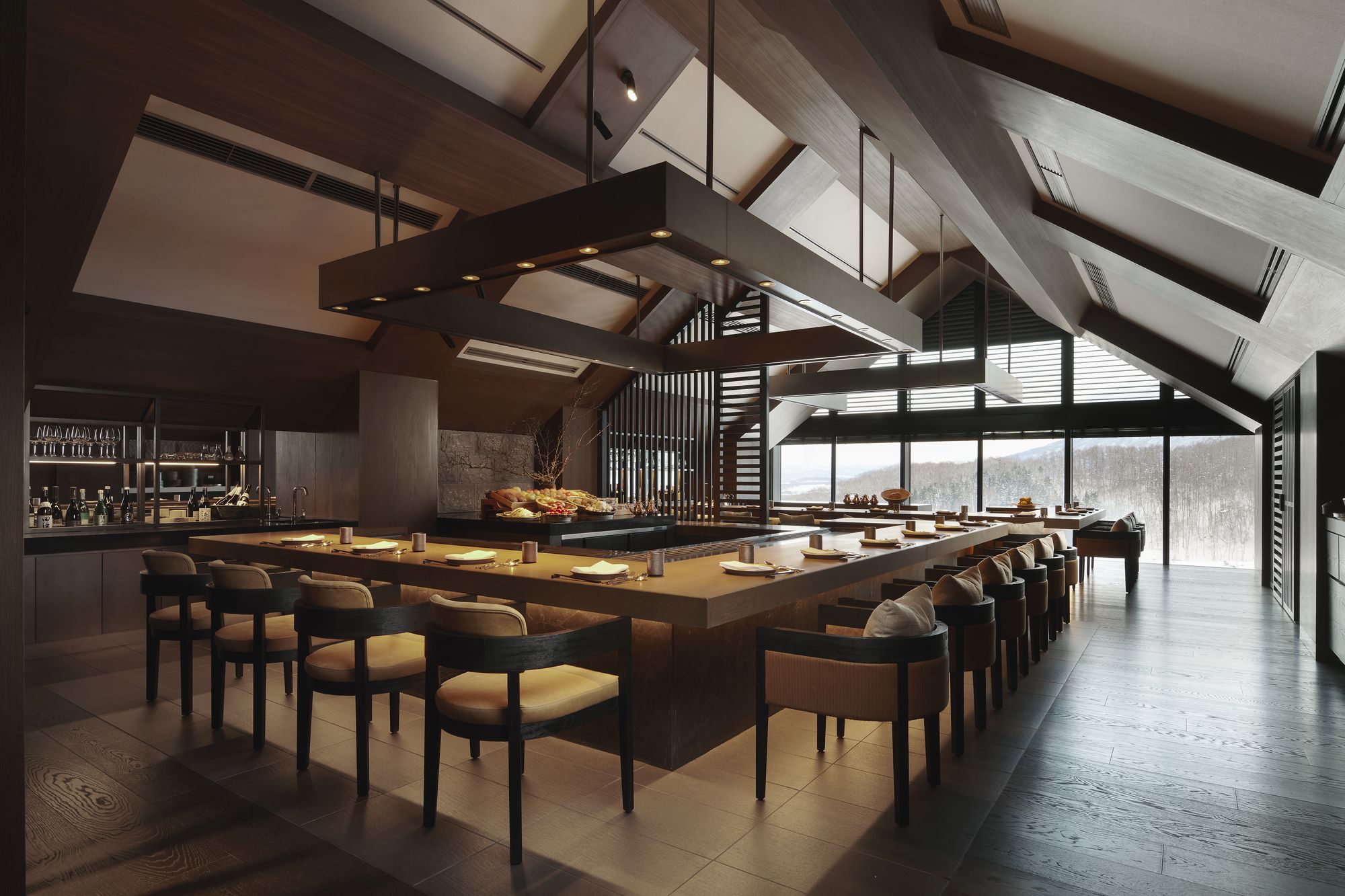 The teppan counter under a high wooden ceiling