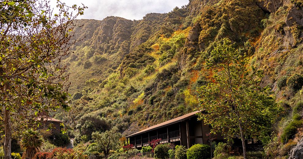 A ranch-style building tucked into the green walls of Aliso Canyon