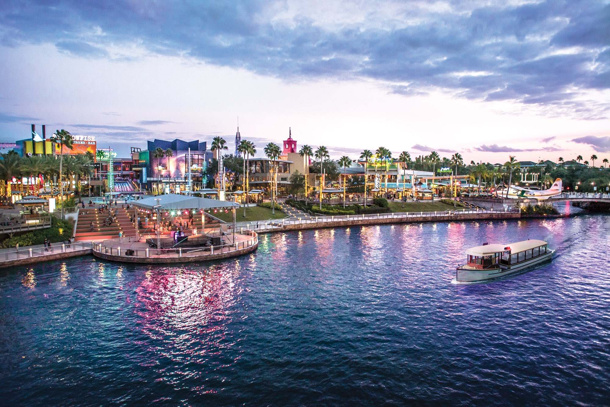 A water taxi crossing the lagoon at Universal CityWalk at sunset