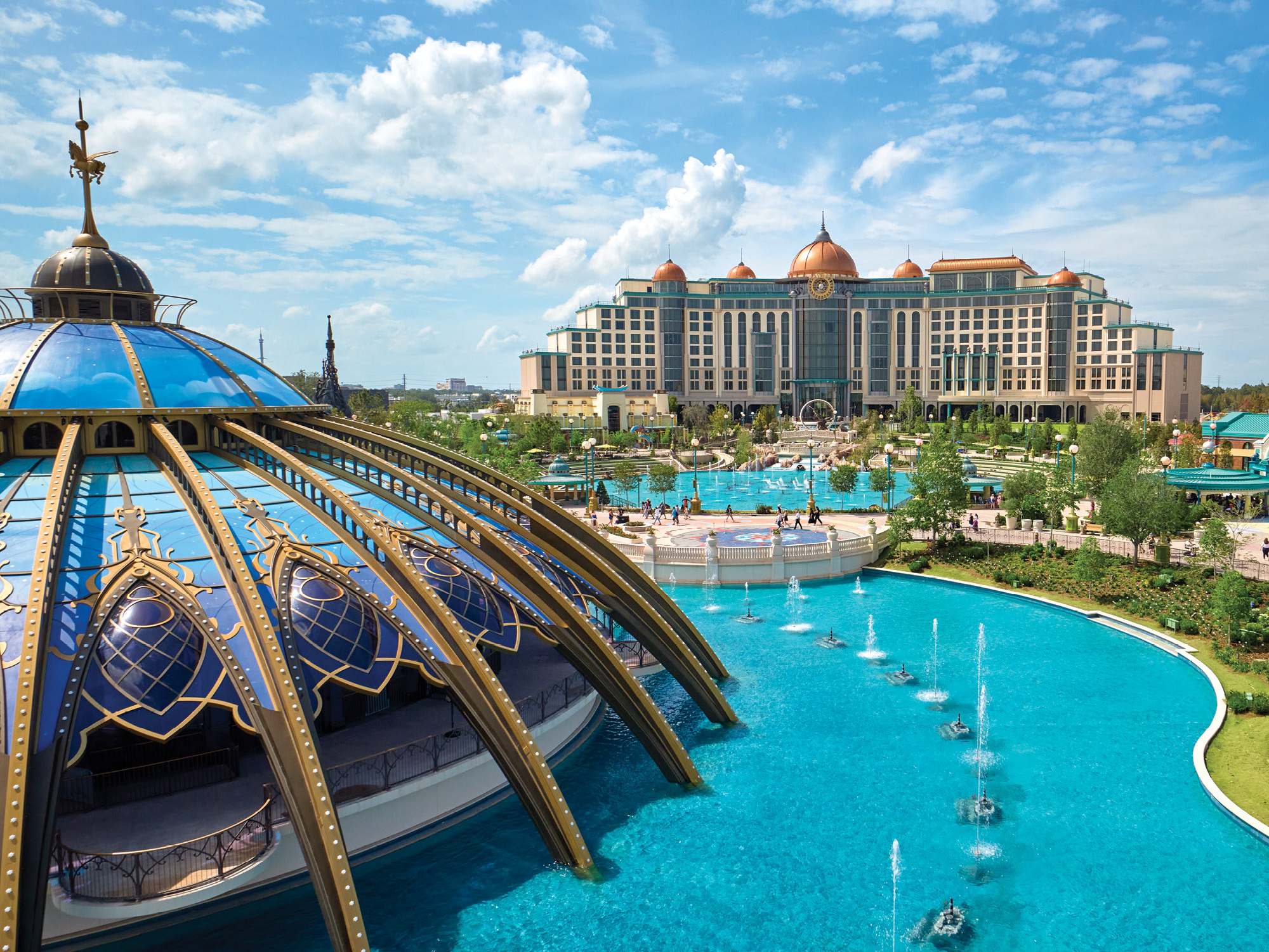 Universal Helios Grand Hotel across a turquoise lagoon in Universal Epic Universe
