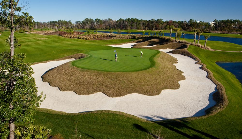 A green ringed by white sand bunkers on the resort golf course