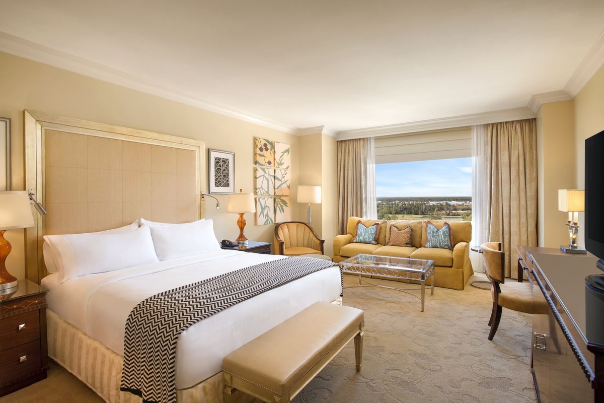 A high-floor king room with a sofa by a wide window